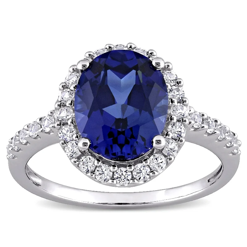 Ladies engagement ring with tanzanite-Miadora 10k White Gold Oval-cut Created Blue and White Sapphire Halo Engagement Ring