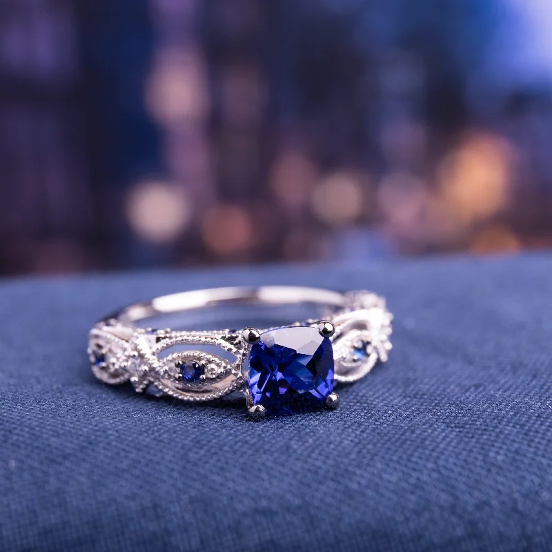 Ladies engagement ring with fancy diamonds-Cushion-cut Created Blue Sapphire and Diamond Vintage Infinity Engagement Ring in 10k White Gold by Miadora